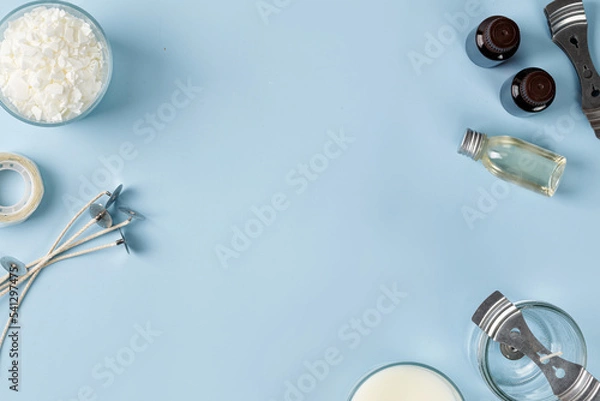 Fototapeta Tools, Equipment for candles making. Jar with wick, coconut or organic soy wax, fragrance. Flatlay, top view. Copy space. Blue background