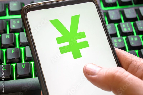 Fototapeta Smartphone with yen symbol on screen phone with technology green colored keyboard background