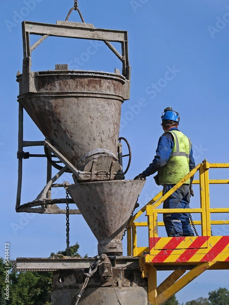 Obraz Worker pours cement into the well, close-up