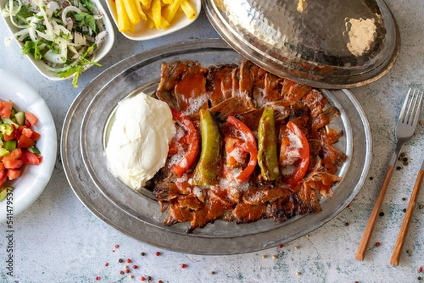 Fototapeta Turkish iskender kebab on gray background. Traditional flavors. Doner kebab made from beef and lamb. close up