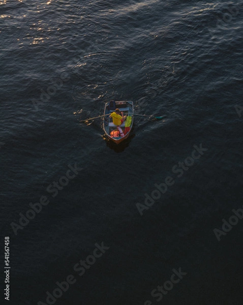 Obraz A man is rowing a boat