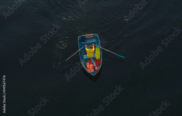 Obraz A man is rowing a boat