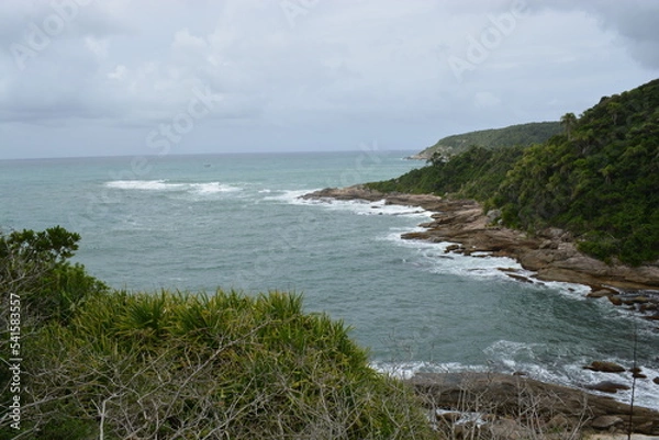 Fototapeta Beach with stones in cloudy day.
