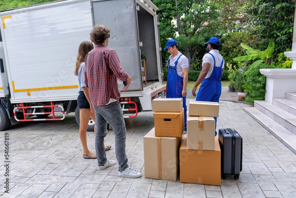 Obraz Professional goods move service use truck carry personal belongings door to door transport delivery handover boxes luggage one by one and keep stack on the floor before transfer to place in house