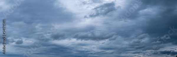 Obraz Panorama of cumulus fluffy white and dark gray storm clouds in rainy weather.