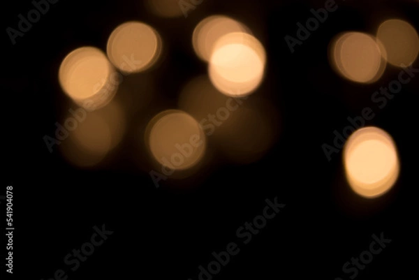 Fototapeta Golden bokeh light isolated on black background