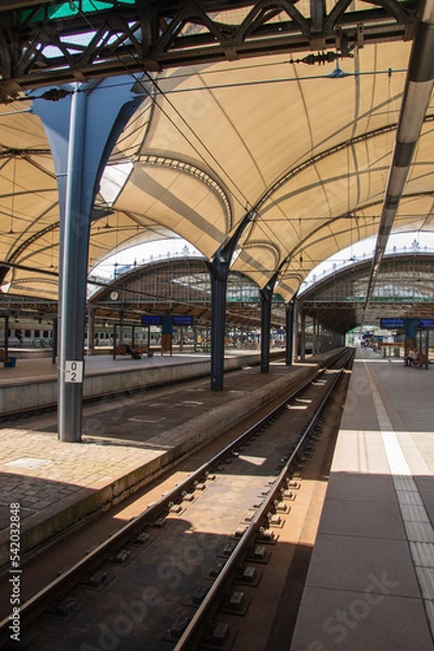 Fototapeta Railway station partially covered on a sunny day. Shade.