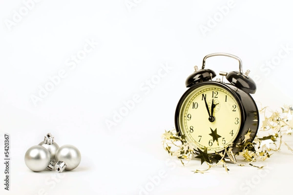 Fototapeta The clock is showing almost midnight on New Year night