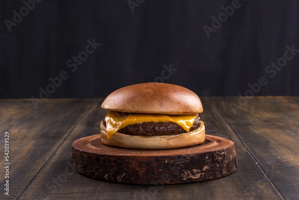 Obraz delicious fast food cheeseburger on a rustic wooden table