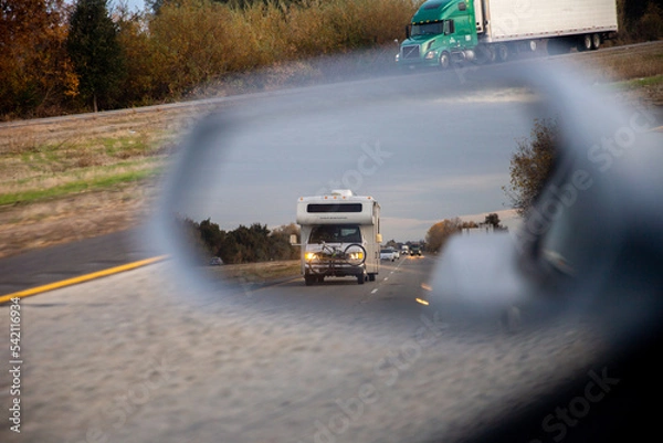 Fototapeta RV through side view mirror on road