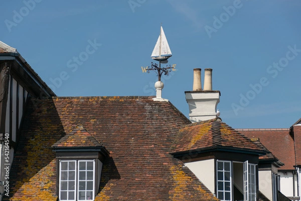 Fototapeta A weather vane on top of a roof