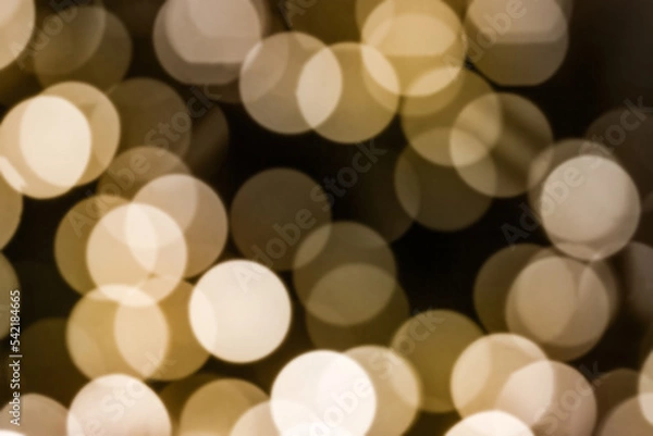 Fototapeta beautiful abstract background - highlights from a garland, a blurry image of a warm yellow bokeh