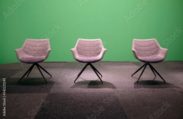 Fototapeta Three empty chairs in a studio with green screen