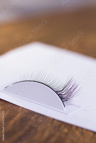 Fototapeta The process of training eyelash extension 3d close-up on a white background