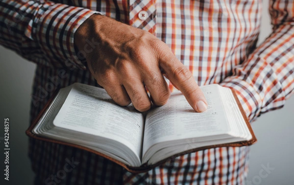 Fototapeta Man reading the bible pointing the text