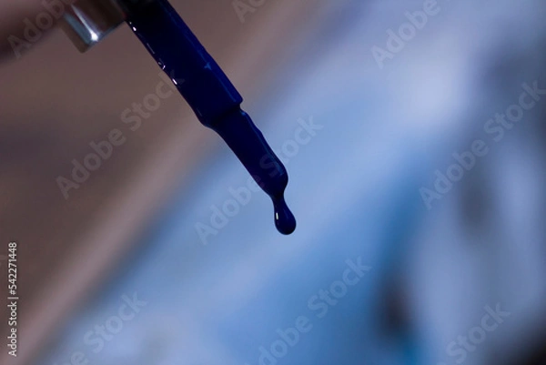 Fototapeta A drop of blue lacquer on a brush close-up