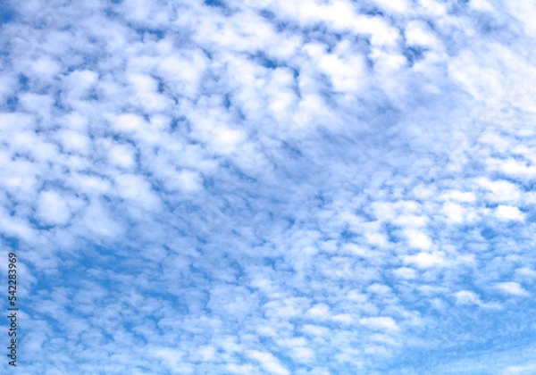 Obraz White cumulus clouds against blue sky. Atmospheric phenomena.	