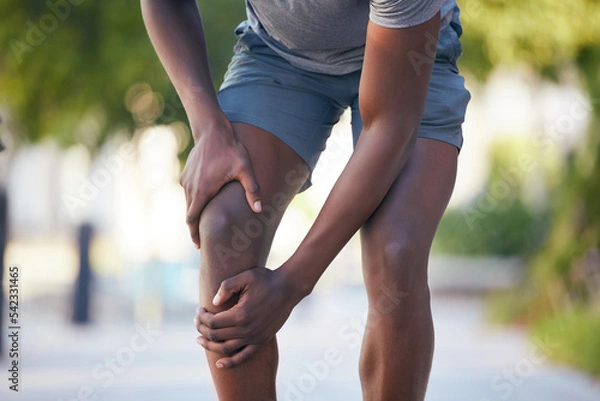 Obraz Knee pain, arthritis and legs of man runner during training, running or cardio workout in park. Muscle, leg and sport injury by athletic guy on morning run, pain and inflammation, fracture and hurt