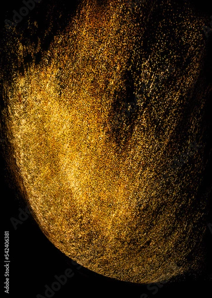 Fototapeta Golden sequins glisten with dust isolated on a black background. vertical abstract background with sparkling dust, space for text