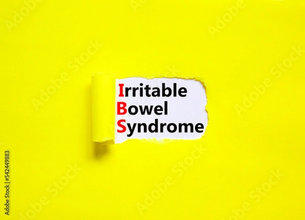 Fototapeta IBS irritable bowel syndrome symbol. Concept words IBS irritable bowel syndrome on white paper on a beautiful yellow background. Medical and IBS irritable bowel syndrome concept. Copy space.