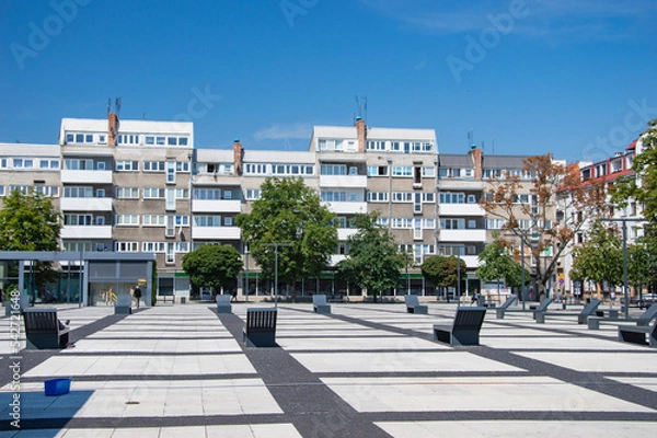 Fototapeta Wroclaw square lined with concrete elements and benches. Summer.