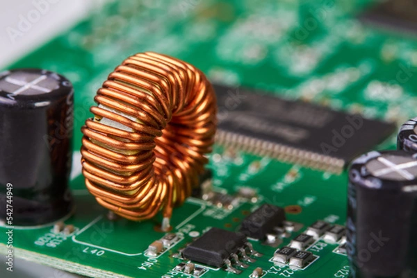 Obraz Orange inductor with copper wire on green printed circuit board detail