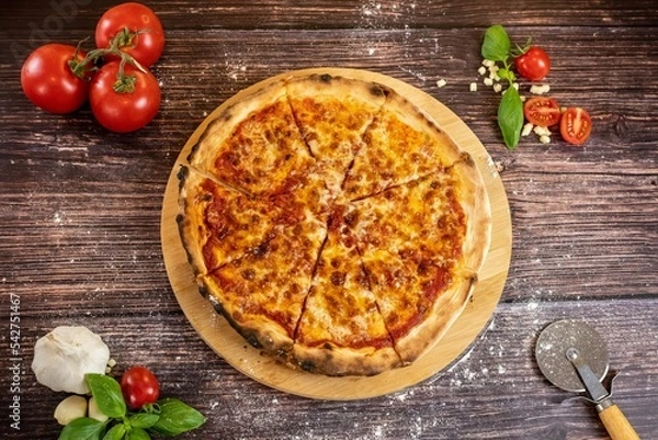 Fototapeta Pizza Margherita with ingredents top view on wooden table