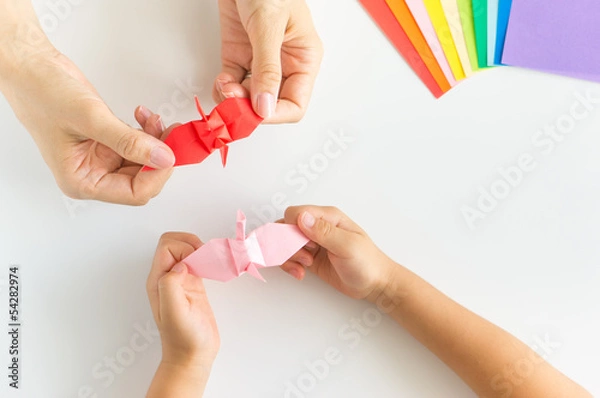 Obraz 親子で折り鶴を折って羽を広げる