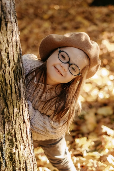 Fototapeta Happy child with down syndrome enjoying in autumn park