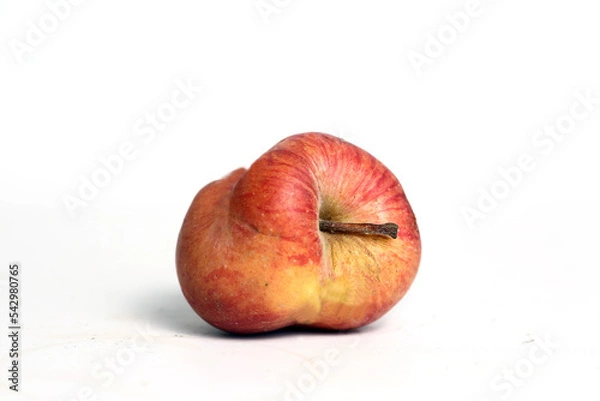 Obraz Concept of ugly food - red apple on white background
