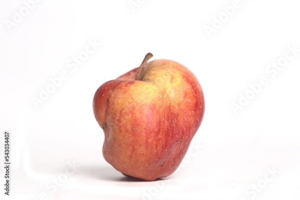 Obraz Concept of ugly food - red apple on white background