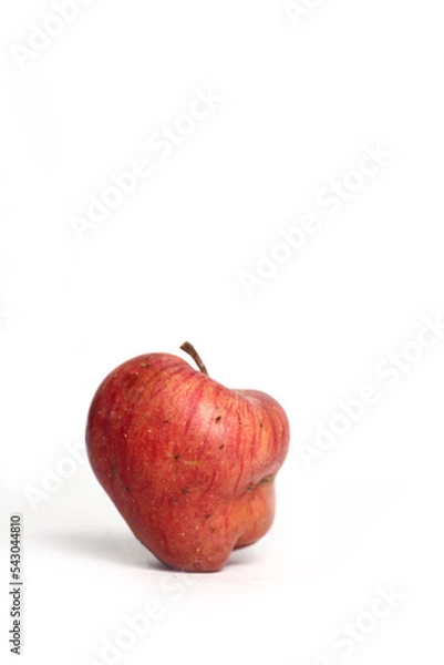 Obraz Concept of ugly food - red apple on white background