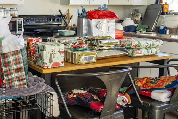 Obraz Christmas presents on an island in a cluttered kitchen.