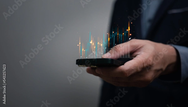 Fototapeta business man using mobile phone for trading stock or crypto currency. urban investment life style using digital communication technology