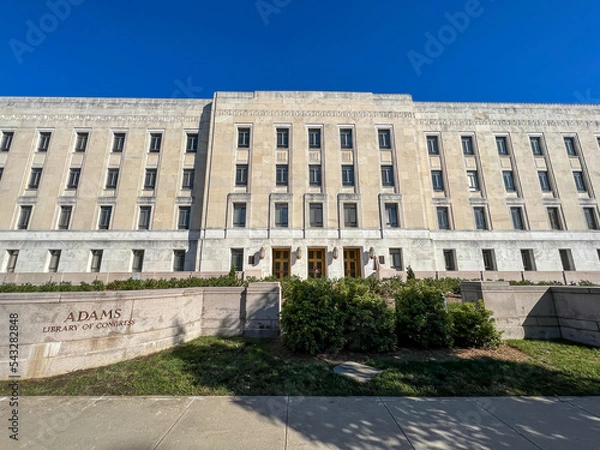 Fototapeta The Library of Congress John Adams building on Capitol Hill in Washington DC￼. Seen from 2nd Street SE on a sunny fall day with blue skies and no clouds.￼
