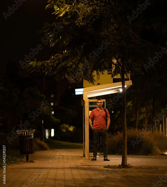 Obraz Man waits in the bus station at night