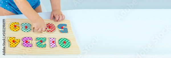 Obraz The child learns numbers at the table. Selective focus.