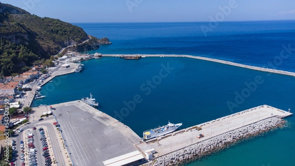 Fototapeta Aerial footage of shipyard in Karlovasi, Samos island behind wave breakers on a clear summer morning