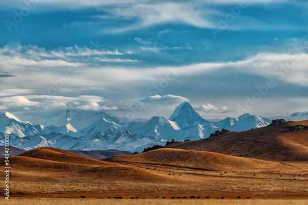 Fototapeta Northern Tien Shan mountain range with Khan Tengri peak in southeast Kazakhstan under a cloudy sky