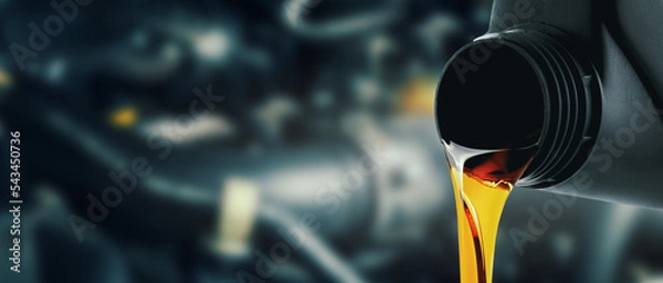 Fototapeta change and pour new car engine oil into the motor. banner with copy space