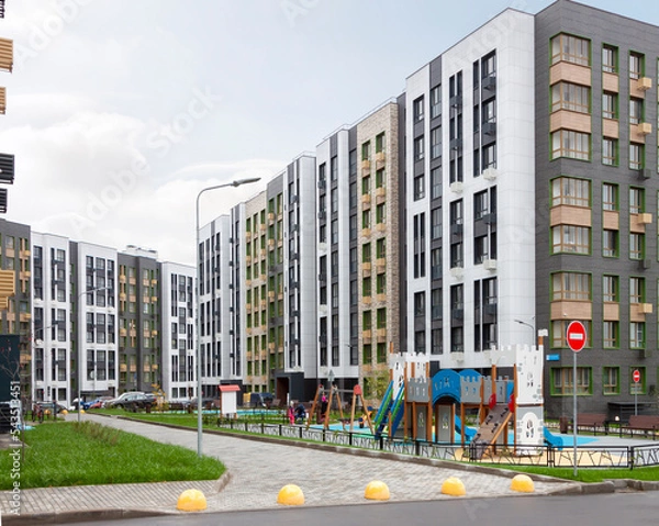 Fototapeta Low-rise houses mixed-use urban multi-family residential district area development overcast cloudy sky background