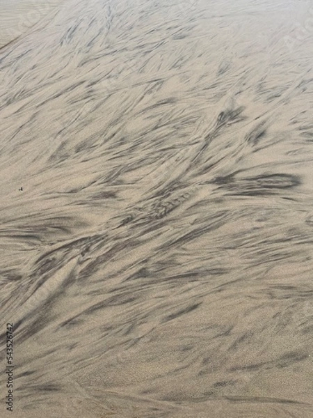 Fototapeta sand and water making random abstract patterns 