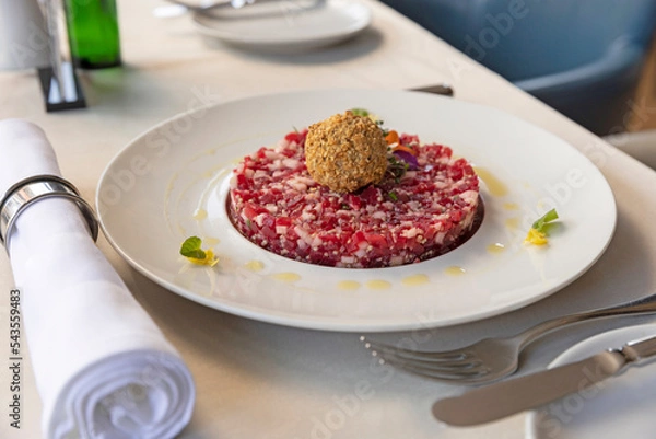 Obraz Tartare beef served on a white plate in the restaurant