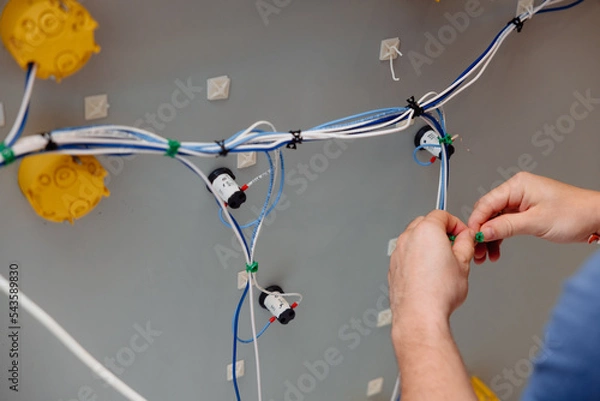 Obraz Electrician works cable checking energy