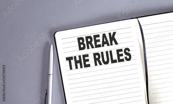 Fototapeta BREAK THE RULES word on the notebook with pen