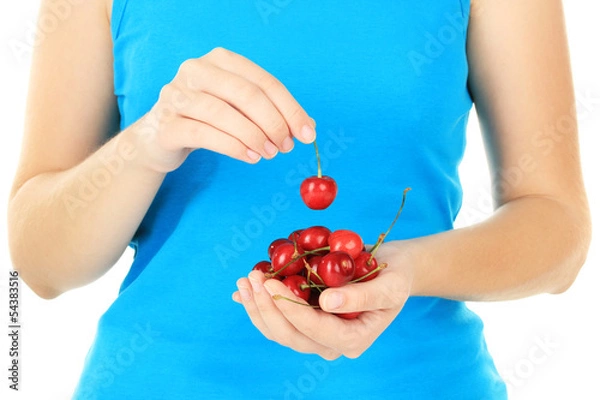 Fototapeta Cherry berries in hands close up