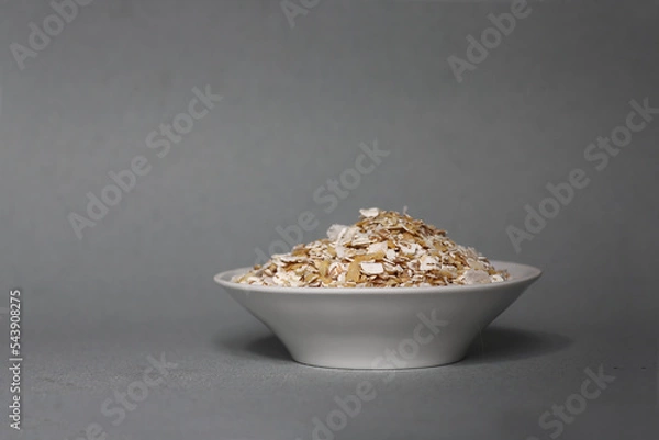 Obraz white plate oatmeal isolated on gray background