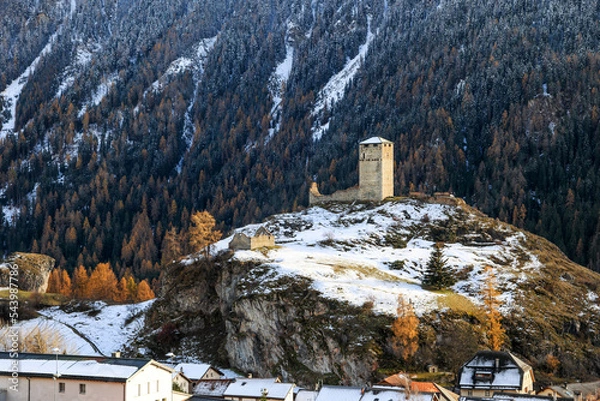Obraz Ruins Steinsberg from the ancient Medieval Castle Steinsberg over the Swiss Alp village Ardez with snow mountain at the background in Engadin valley, Graubunden Canton