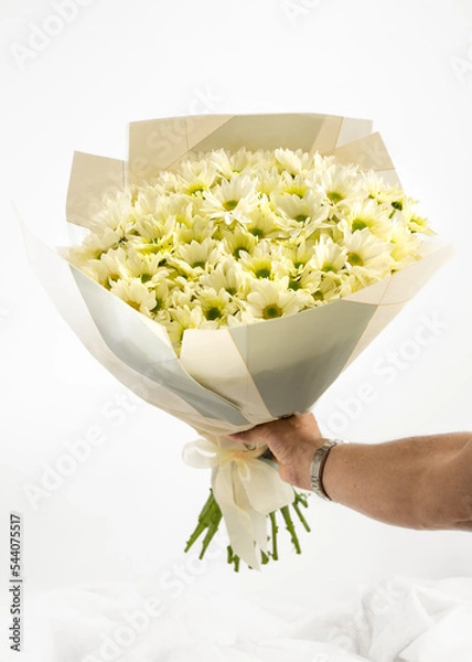 Fototapeta bouquet of flowers isolated on white background with hand