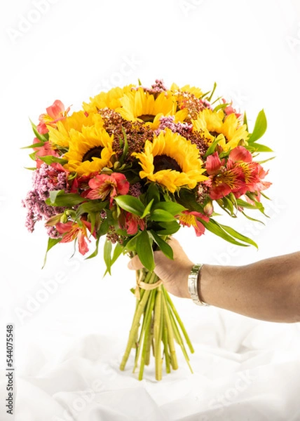 Fototapeta bouquet of flowers isolated on white background with hand